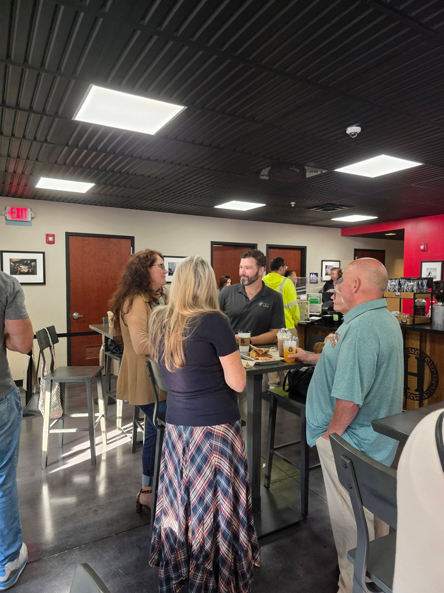 Chamber members talking around high-top tables at the High Grounds Lounge