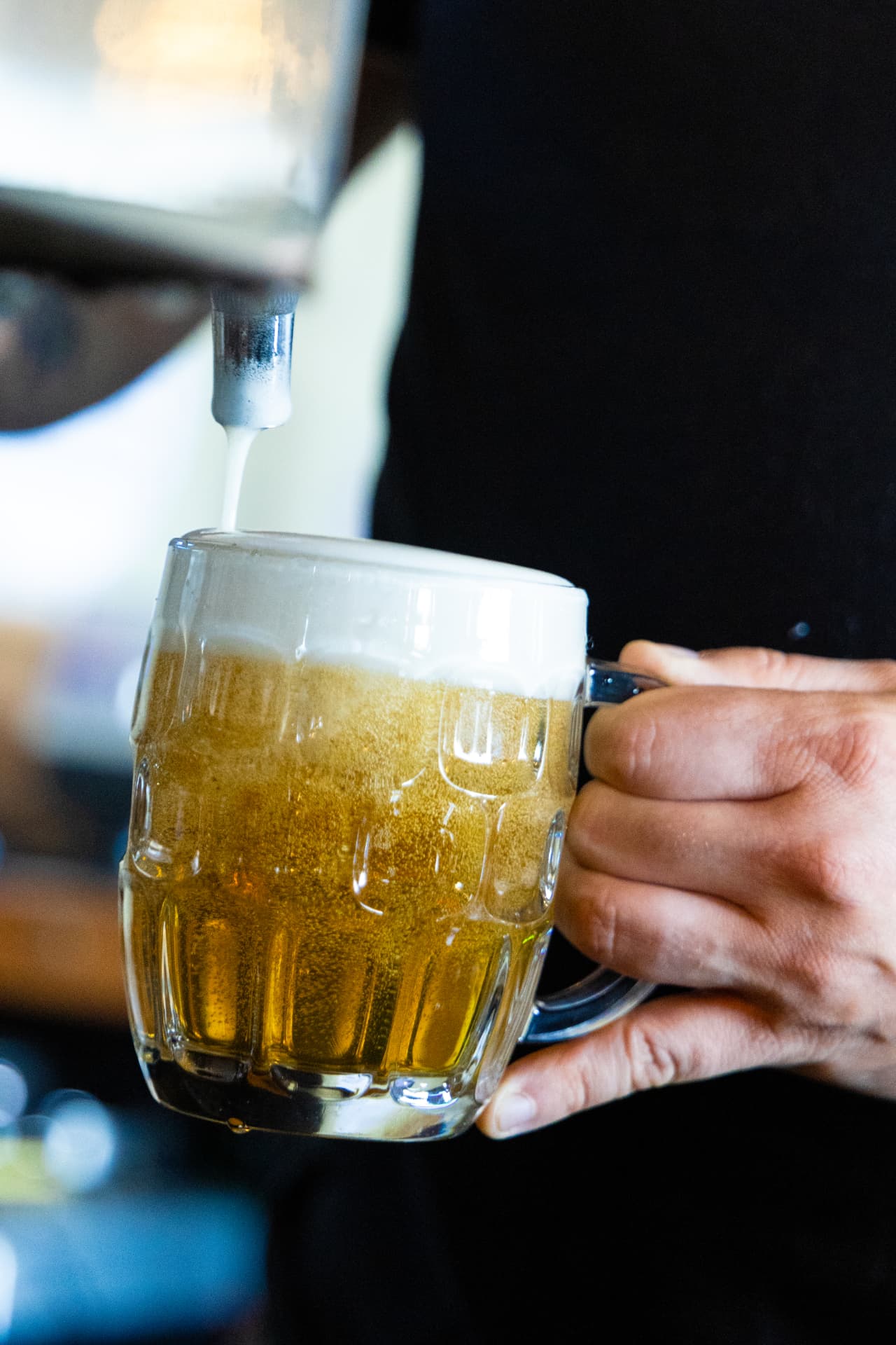Beer pouring from the tap into a dimpled glass mug at Death of the Fox in Clarksboro