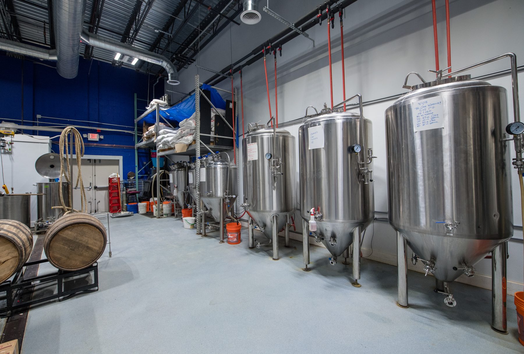Fermentation tanks and barrels in the Death of the Fox brewhouse